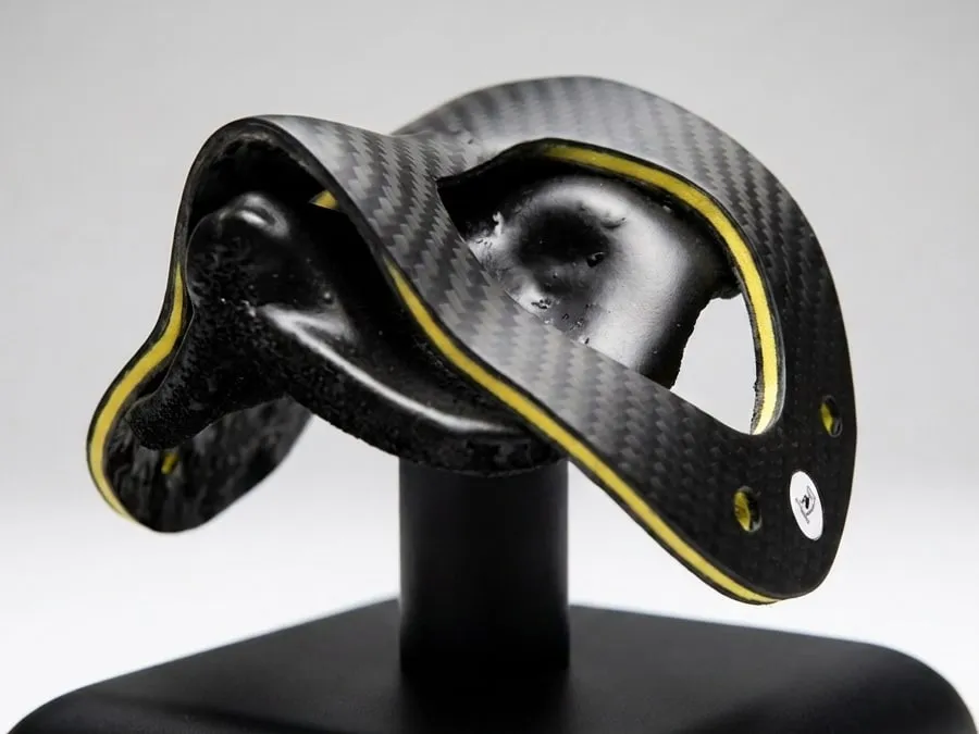 Carbon fibre mask with Kevlar trim on its stand