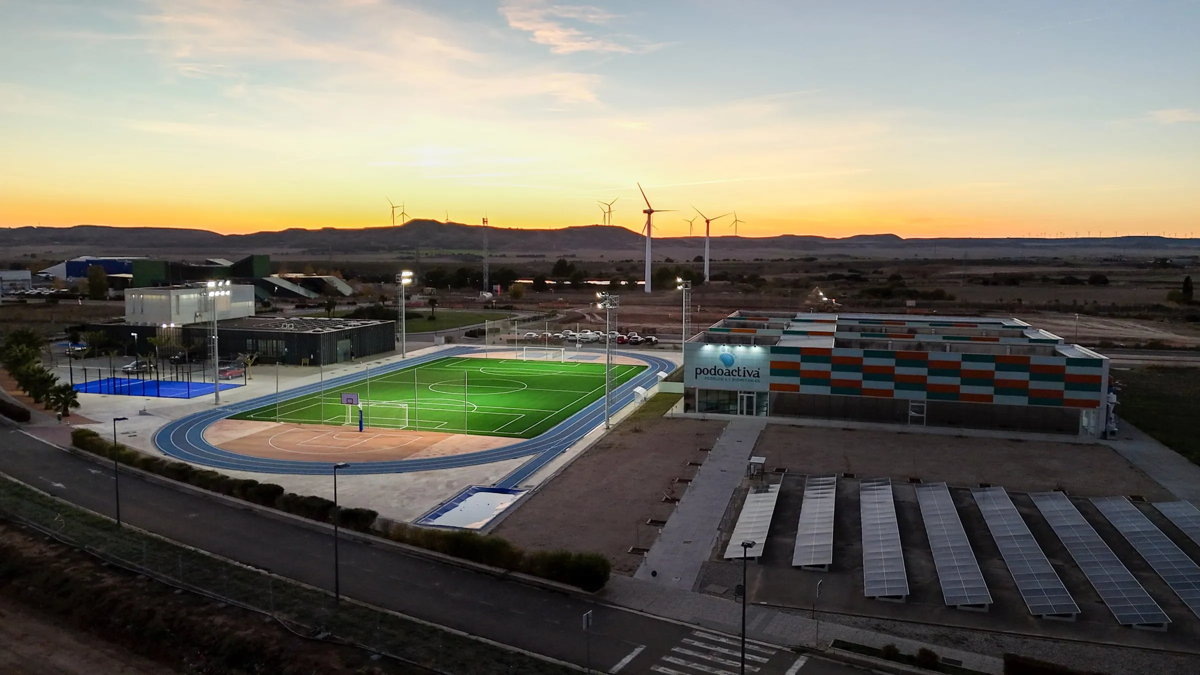 Aerial view of the sports campus with an athletics track and instrumented pitches and courts