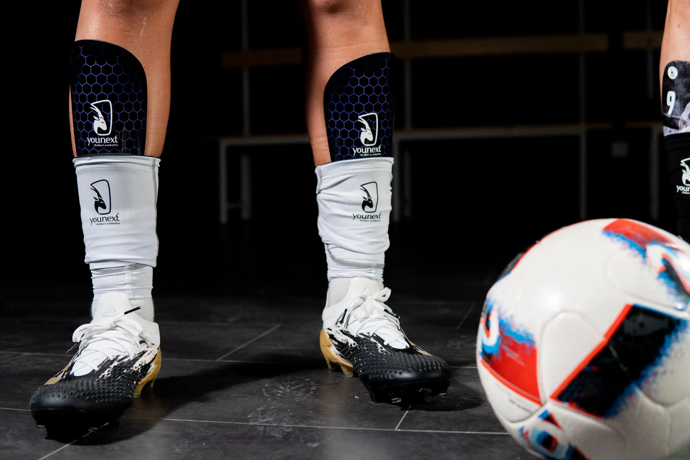 Footballer wearing YouNext custom shin guards in the dressing room